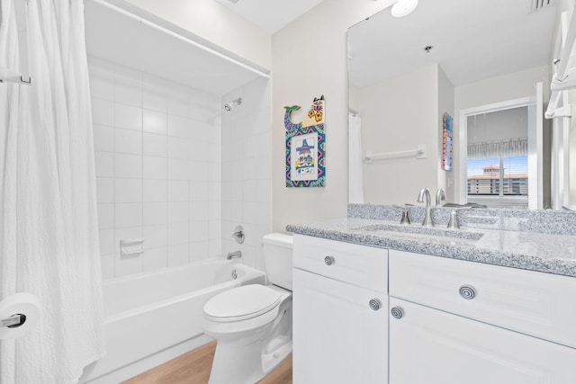 full bathroom featuring vanity, toilet, hardwood / wood-style flooring, and shower / bath combination with curtain