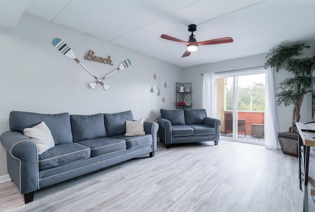 living room with ceiling fan and light hardwood / wood-style floors