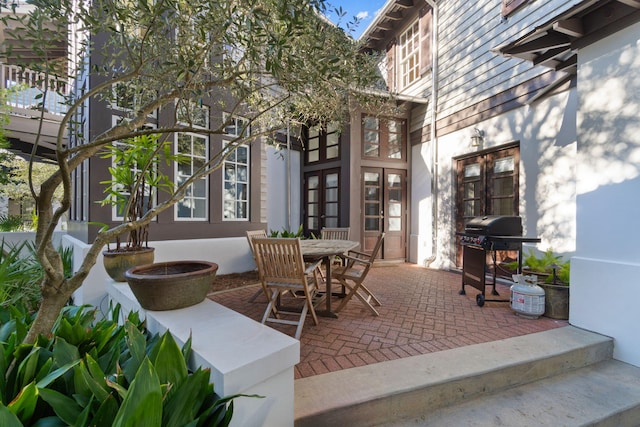 view of terrace featuring french doors and a grill