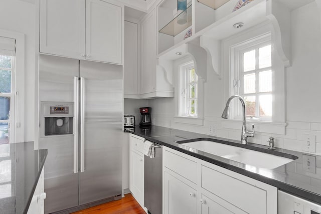 kitchen featuring hardwood / wood-style flooring, stainless steel appliances, and a wealth of natural light