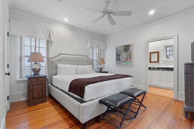 bedroom with light hardwood / wood-style flooring, ceiling fan, crown molding, and connected bathroom