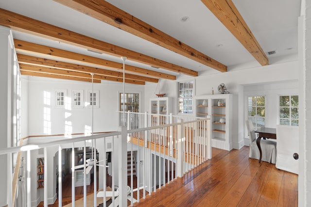 hallway featuring beam ceiling and hardwood / wood-style floors