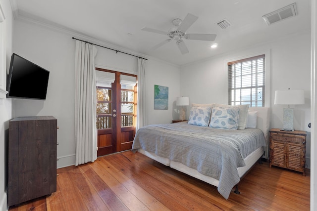 bedroom featuring hardwood / wood-style floors, ceiling fan, and ornamental molding