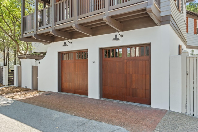 16 S Green Turtle Ln, Inlet Beach, FL 32461 - entrance to property with a garage, stucco siding, fence, decorative driveway, and a balcony