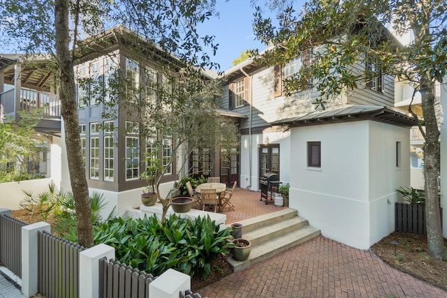 16 S Green Turtle Ln, Inlet Beach, FL 32461 - exterior space featuring fence, a patio, stucco siding, and french doors