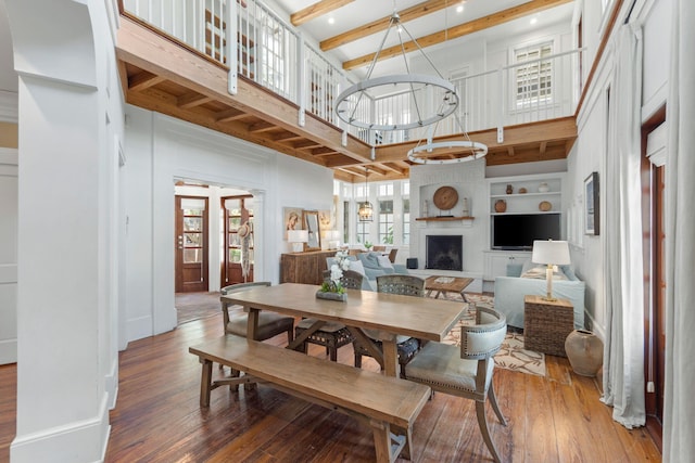16 S Green Turtle Ln, Inlet Beach, FL 32461 - dining space with a fireplace, a towering ceiling, light wood-type flooring, and beam ceiling