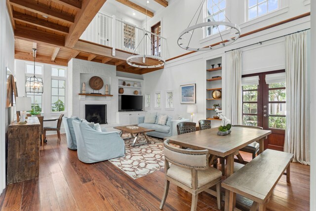 16 S Green Turtle Ln, Inlet Beach, FL 32461 - living room featuring wood-type flooring, beamed ceiling, built in shelves, and a high ceiling