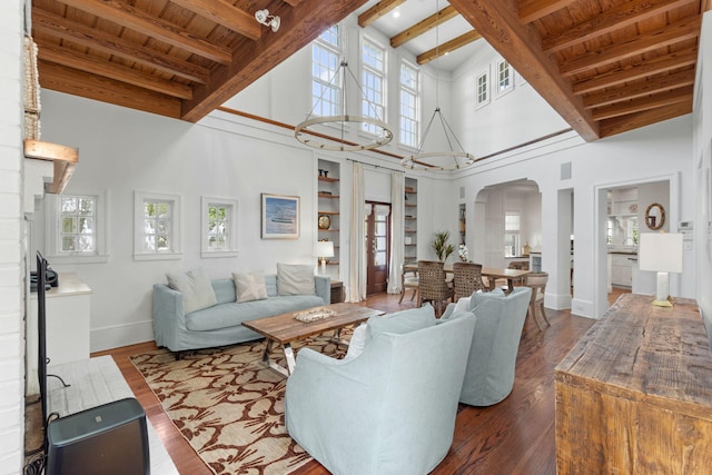 16 S Green Turtle Ln, Inlet Beach, FL 32461 - living room with wooden ceiling, baseboards, a towering ceiling, arched walkways, and beamed ceiling