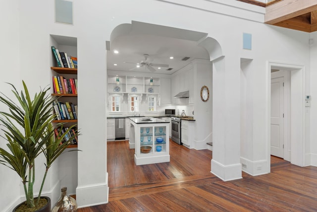 16 S Green Turtle Ln, Inlet Beach, FL 32461 - kitchen featuring open shelves, stainless steel appliances, white cabinetry, arched walkways, and under cabinet range hood