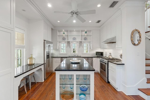 16 S Green Turtle Ln, Inlet Beach, FL 32461 - kitchen with dark countertops, white cabinetry, ceiling fan, under cabinet range hood, and appliances with stainless steel finishes