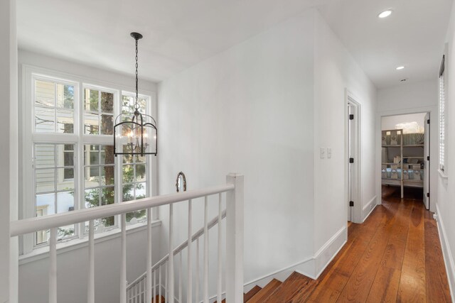 16 S Green Turtle Ln, Inlet Beach, FL 32461 - corridor with wood finished floors, an upstairs landing, recessed lighting, an inviting chandelier, and baseboards