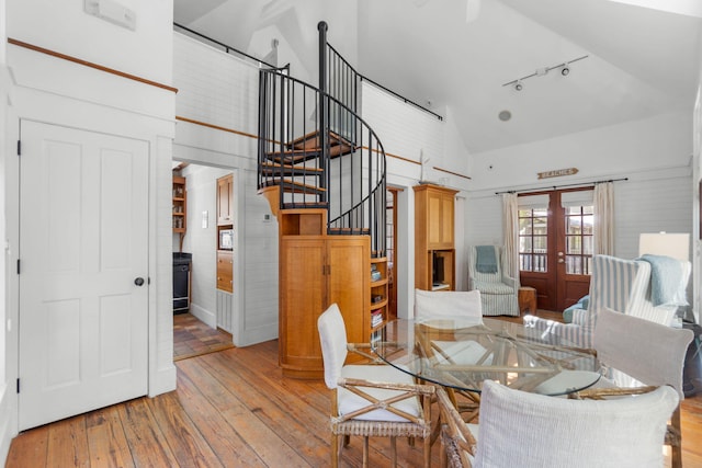 16 S Green Turtle Ln, Inlet Beach, FL 32461 - dining space with french doors, track lighting, high vaulted ceiling, stairway, and light wood-type flooring