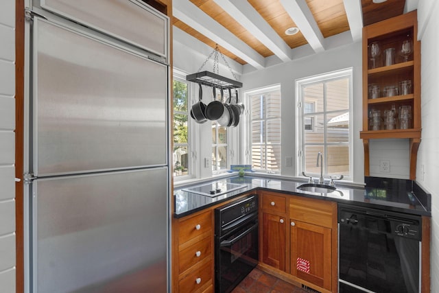 16 S Green Turtle Ln, Inlet Beach, FL 32461 - kitchen featuring a sink, brown cabinets, black appliances, dark countertops, and beam ceiling
