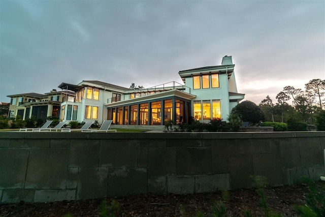 view of back house at dusk