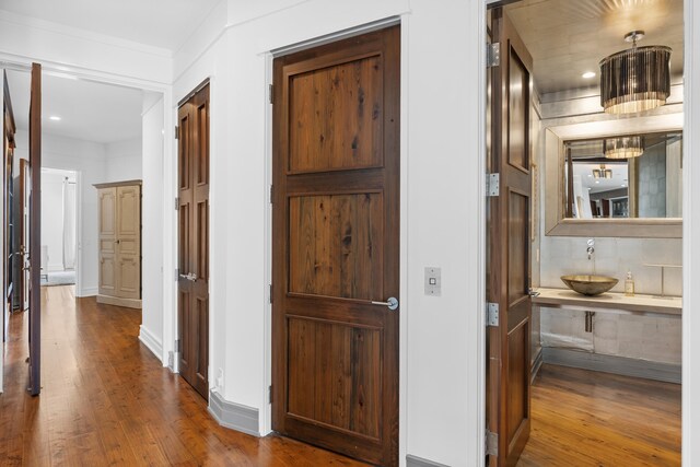 hallway with dark wood-type flooring and sink