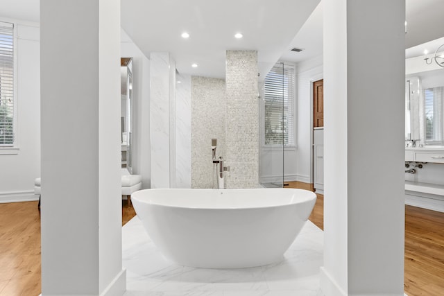 bathroom featuring a bathing tub, plenty of natural light, and hardwood / wood-style flooring