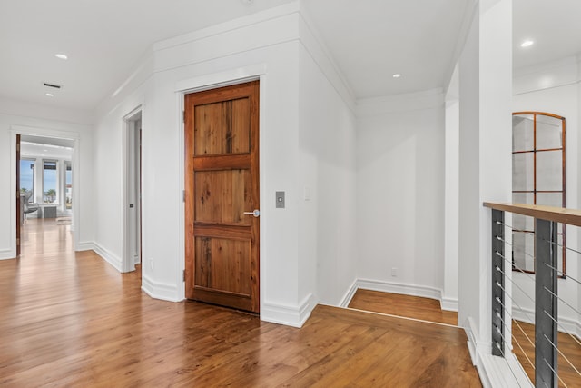 hallway with light hardwood / wood-style floors