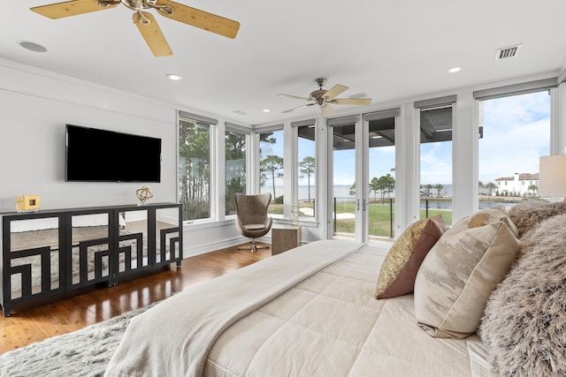 bedroom with ceiling fan, light hardwood / wood-style floors, and access to exterior