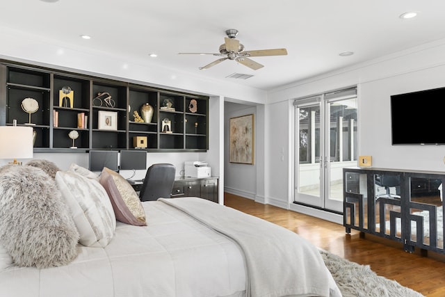 bedroom featuring hardwood / wood-style floors, multiple windows, ceiling fan, and access to outside