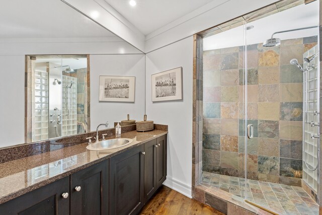 bathroom featuring wood-type flooring, french doors, vanity, and a shower with shower door