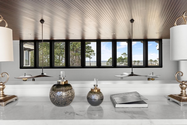 kitchen featuring a healthy amount of sunlight, white cabinetry, and wood ceiling