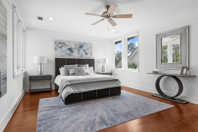 bedroom with ceiling fan and dark wood-type flooring