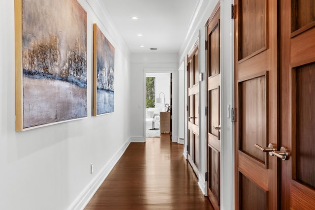 corridor with crown molding and dark hardwood / wood-style floors