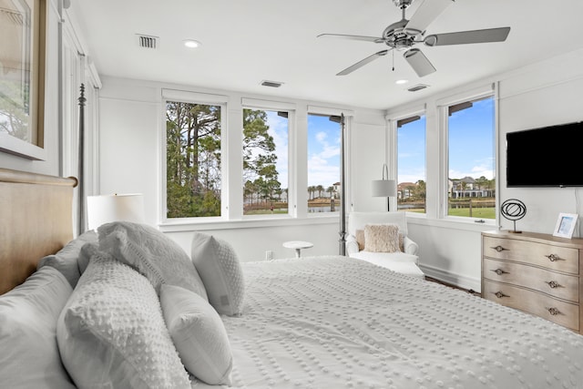 bedroom featuring ceiling fan and multiple windows