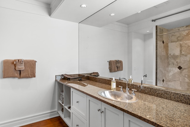 bathroom featuring wood-type flooring and double sink vanity