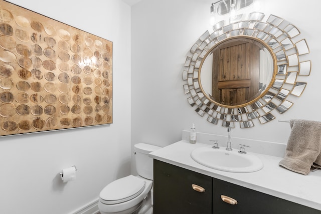 bathroom with toilet and large vanity