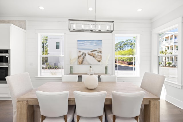 dining room with a chandelier, crown molding, and dark hardwood / wood-style flooring