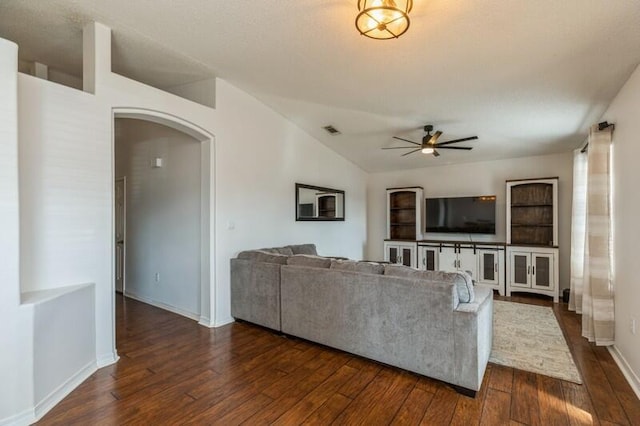 living room with dark hardwood / wood-style floors, ceiling fan, and lofted ceiling