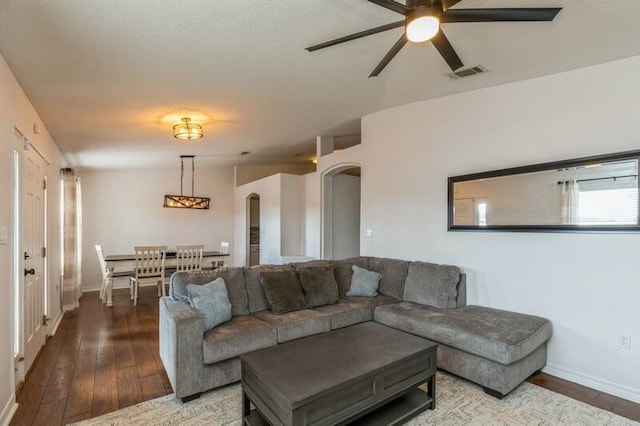 living room with ceiling fan, hardwood / wood-style floors, and vaulted ceiling