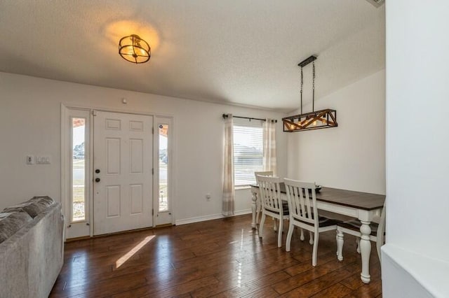 entrance foyer with a textured ceiling and dark wood-type flooring