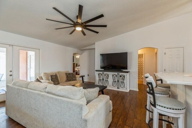 living room featuring ceiling fan, dark hardwood / wood-style flooring, lofted ceiling, and french doors