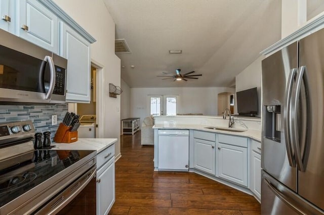 kitchen featuring dark hardwood / wood-style flooring, stainless steel appliances, ceiling fan, sink, and white cabinets