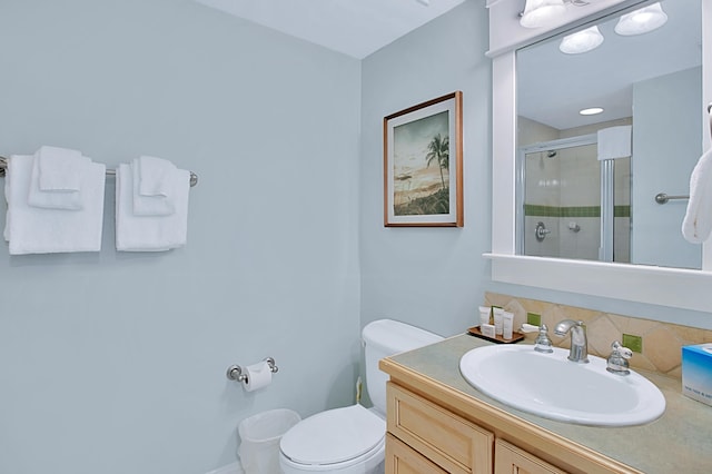 bathroom with decorative backsplash, toilet, and vanity