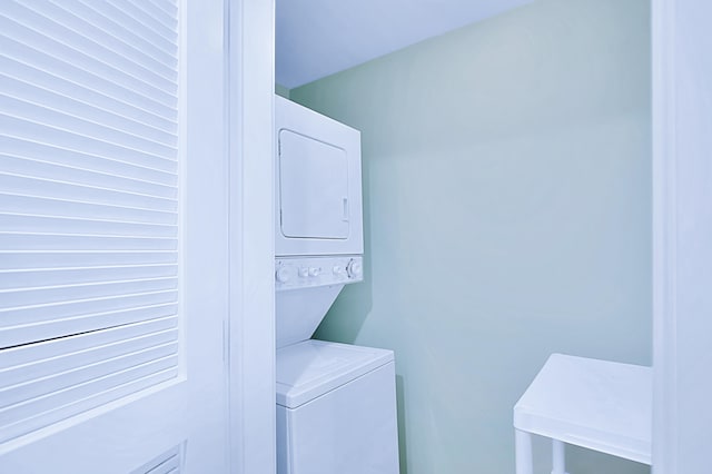 laundry area featuring stacked washer and clothes dryer