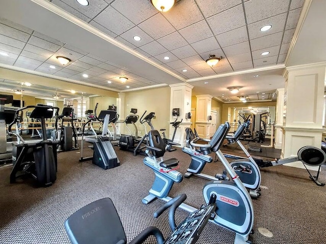 gym featuring carpet, decorative columns, and ornamental molding