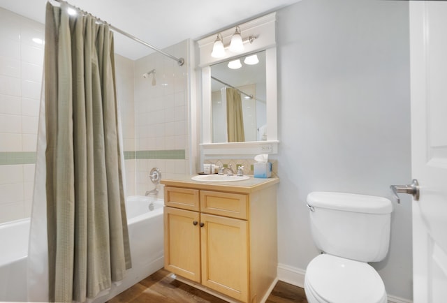 full bathroom with toilet, shower / bath combo, hardwood / wood-style floors, and vanity