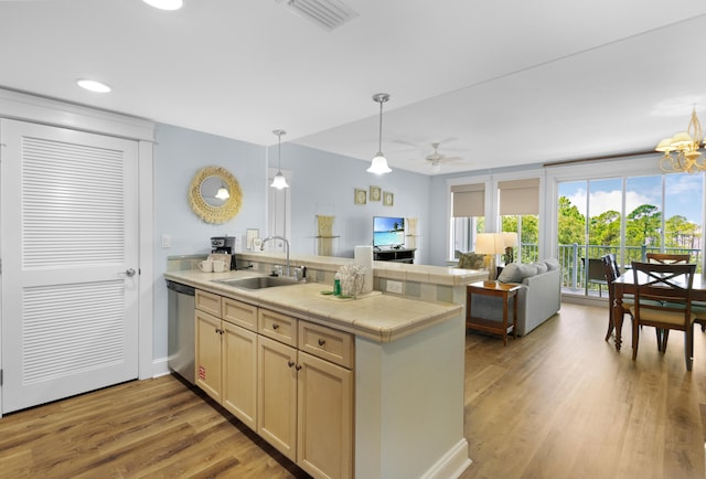 kitchen with hardwood / wood-style floors, sink, kitchen peninsula, dishwashing machine, and ceiling fan