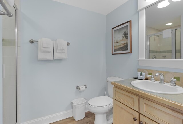 bathroom with vanity, hardwood / wood-style flooring, and toilet