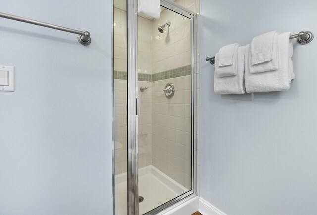 bathroom with a shower with shower door