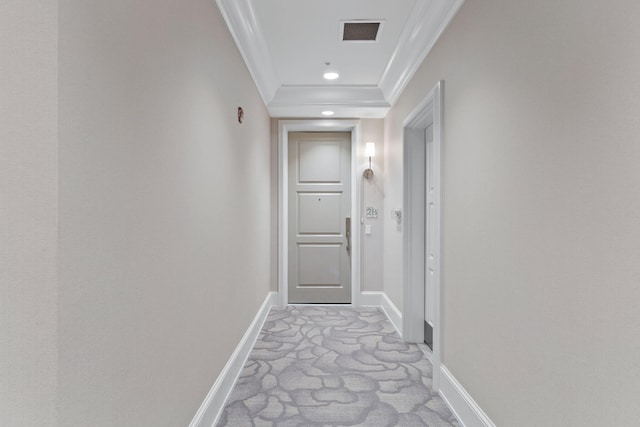 hallway with light colored carpet and crown molding