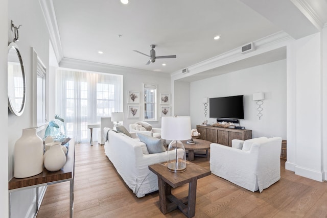 living room featuring ceiling fan, light wood-type flooring, and ornamental molding