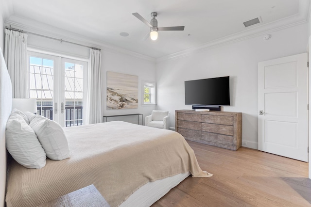 bedroom featuring french doors, ornamental molding, light hardwood / wood-style floors, and ceiling fan