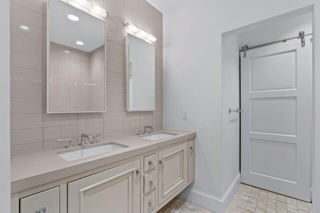 bathroom featuring tile walls, large vanity, double sink, and tile flooring