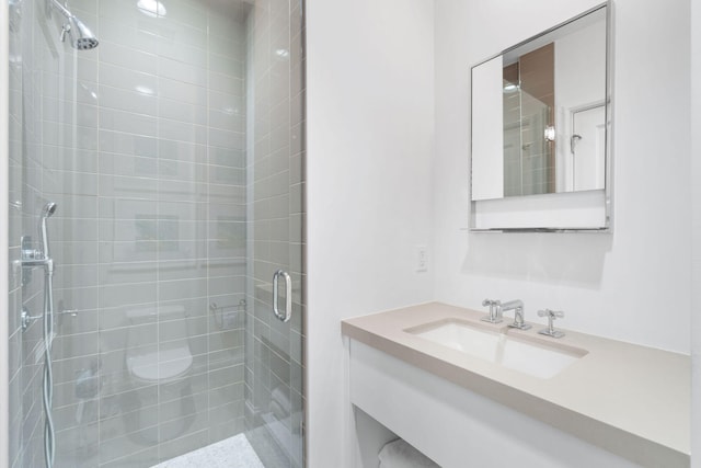 bathroom with an enclosed shower and vanity