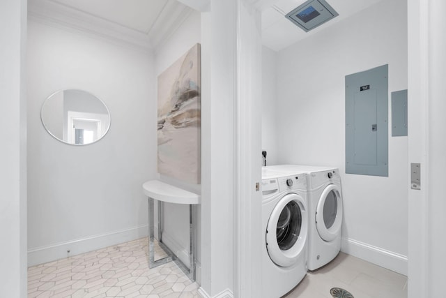 washroom featuring washing machine and dryer, crown molding, and light tile floors