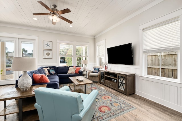 living room with ceiling fan, light hardwood / wood-style floors, and crown molding